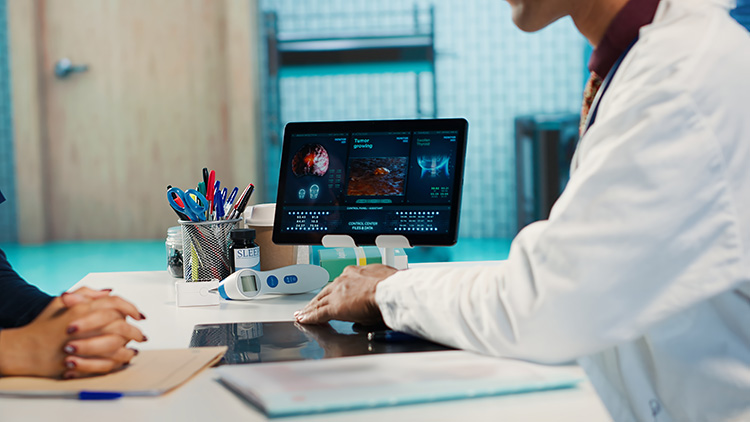 Doctor reviewing patient data on digital screen in clinic