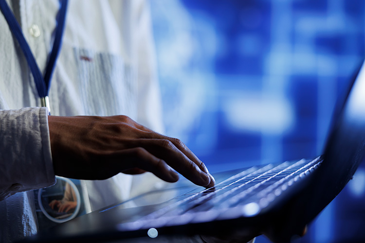 Doctor using laptop for healthcare website management